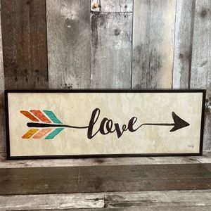 “Love” written in an Arrow Hanging Wall Sign